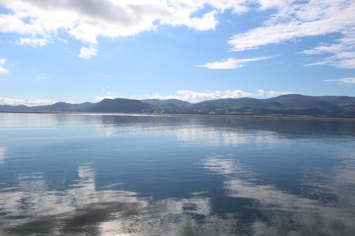 Sailing along Anglesey with a view on mainland Wales