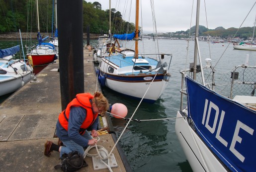 Fastening the boat back on the pontoon.